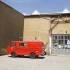 An old red fire brigade minibus is parked in front of a factory building in Munich&rsquo;s Kreativquartier.