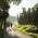 Two cyclists are riding along a tarmac cycle path next to hops fields in Hallertau.