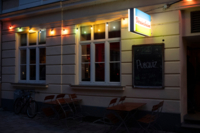 A colourful string of lights, outside above the windows of the football pub "Vereinsheim in Schwabing" in the evening in Munich.