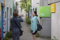 Two visitors of the Olympic Village in Munich in the narrow lanes between the bungalows.