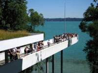 Der Steg eines moderne Geb&auml;udes dient als Aussichtsplattform hoch &uuml;ber einem See