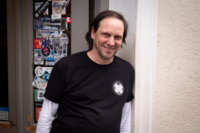 Owner Holger Britzius of the "Stadion an der Schlei&szlig;heimer Stra&szlig;e" leans in the doorway of his football pub in Munich.