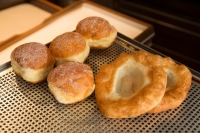 Krapfen and Auszogne on a baking tray in Caf&eacute; Frischhut at the Viktualienmarkt in Munich.