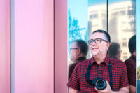 Nicanor Garc&iacute;a, a professional photographer from Spain, in front of a wall.