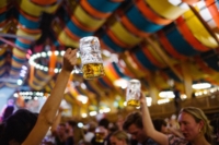 Women with beer mugs toasting in the Sch&uuml;tzenzelt at the Oktoberfest in Munich