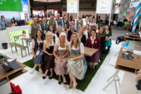 Many people in traditional costume in the simply Munich stand.