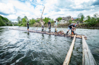 Raft builders assemble a raft on the river.