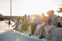 Visitors sit on a wall in the O2 Surftown MUC in Hallbergmoos.
