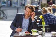 Ein Mann telefoniert in einem Cafe am Gärtnerplatz in München.