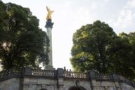 Die goldene Statue der Statue Friedensengel steht zwischen Bäumen im Münchner Stadtteil Bogenhausen
