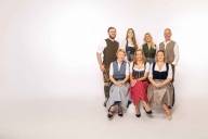 The Munich Convention Bureau team presents itself in traditional costume on the steps of the Glyptothek at Königsplatz.