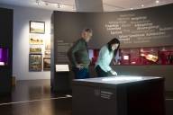 Ein Mann und eine Frau suchen im Heimatatlas im Sudetendeutschen Museum in München nach Orten und Informationen.