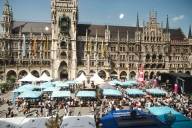 City anniversary celebrations on Munich's Marienplatz with spectator benches and a stage in front of the New Town Hall.