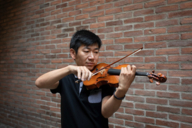 Der Musiker Yusi Chen spielt auf seiner Geige in München.