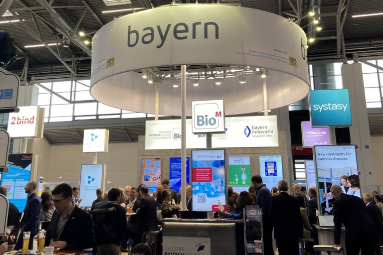 A hall with lots of screens and people.