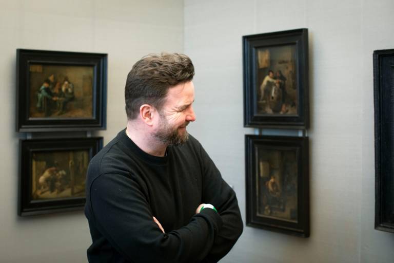 A man looking at paintings in the Alte Pinakothek in Munich