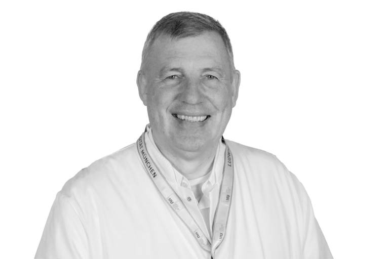 Neurologist and social pediatrician Florian Heinen smiles in a black-and-white photo of him.