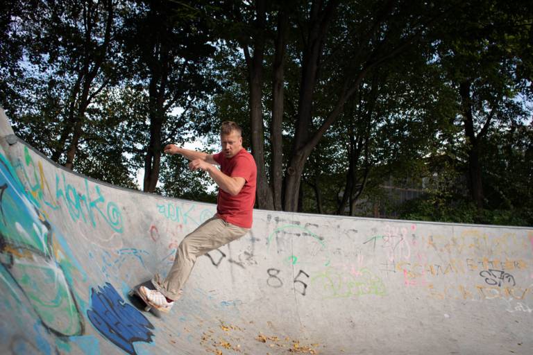 A man practices skating in a bowl at a Munich skate park.