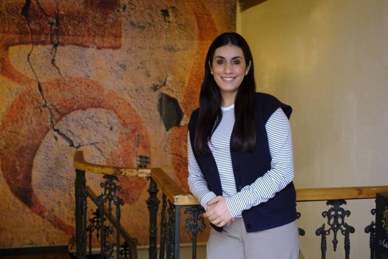 Restaurateur Prateek Reen leans against the stairs in her restaurant Madame Chutney