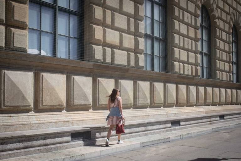 Young woman at Max-Joseph-Platz in the sun in Munich.