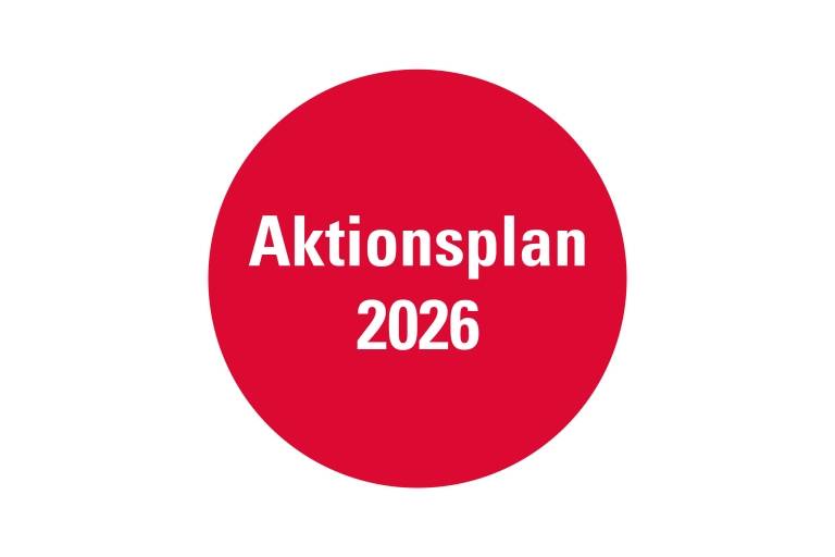 Ein roter Kreis mit der Aufschrift Aktionsplan 2026.